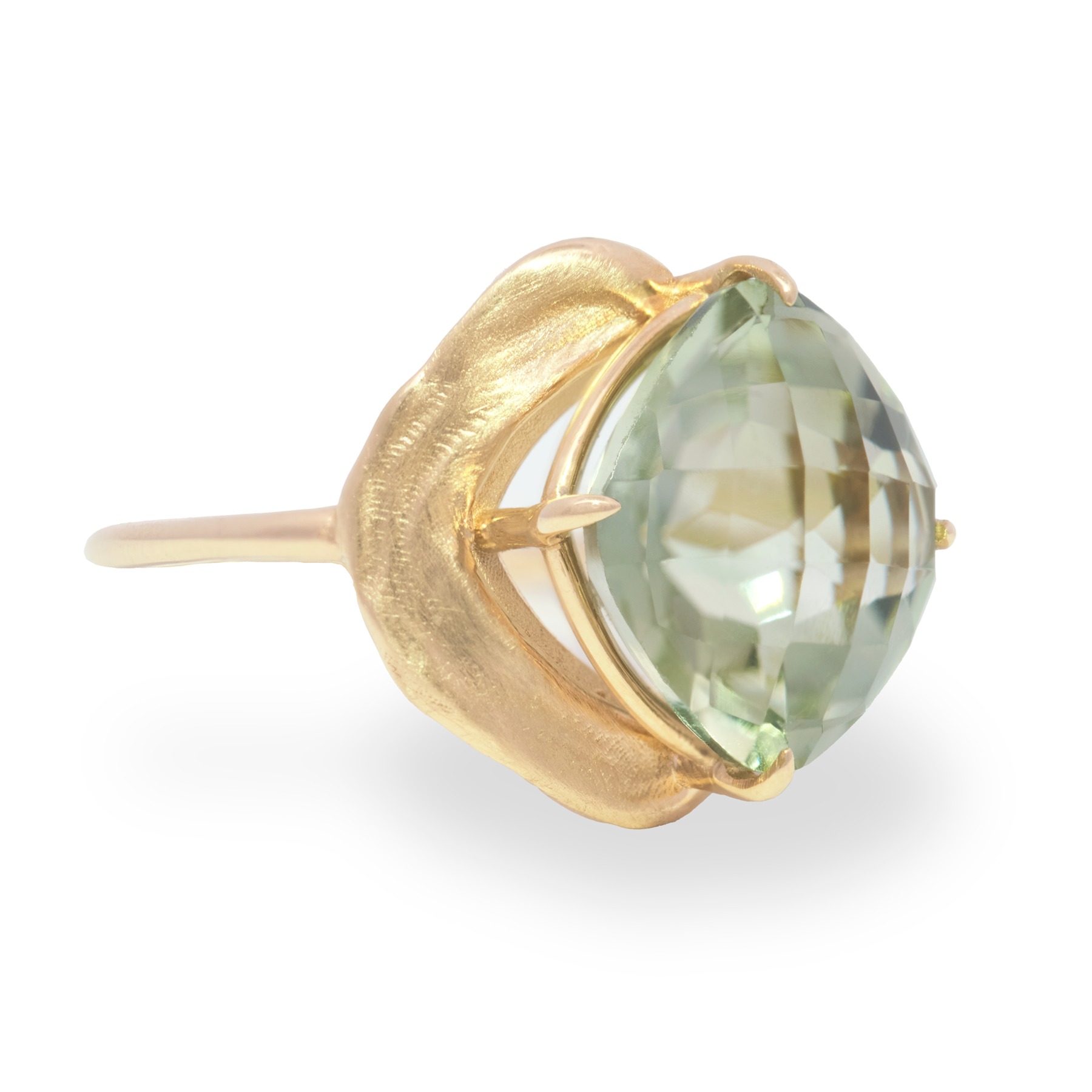 Gold ring with a pale green faceted stone on white